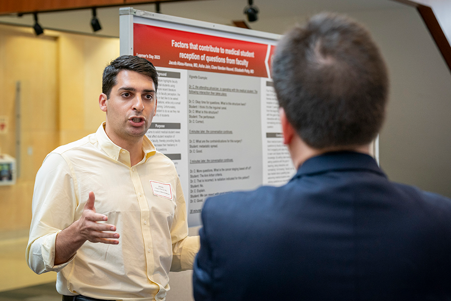 Presenter explaining his research poster